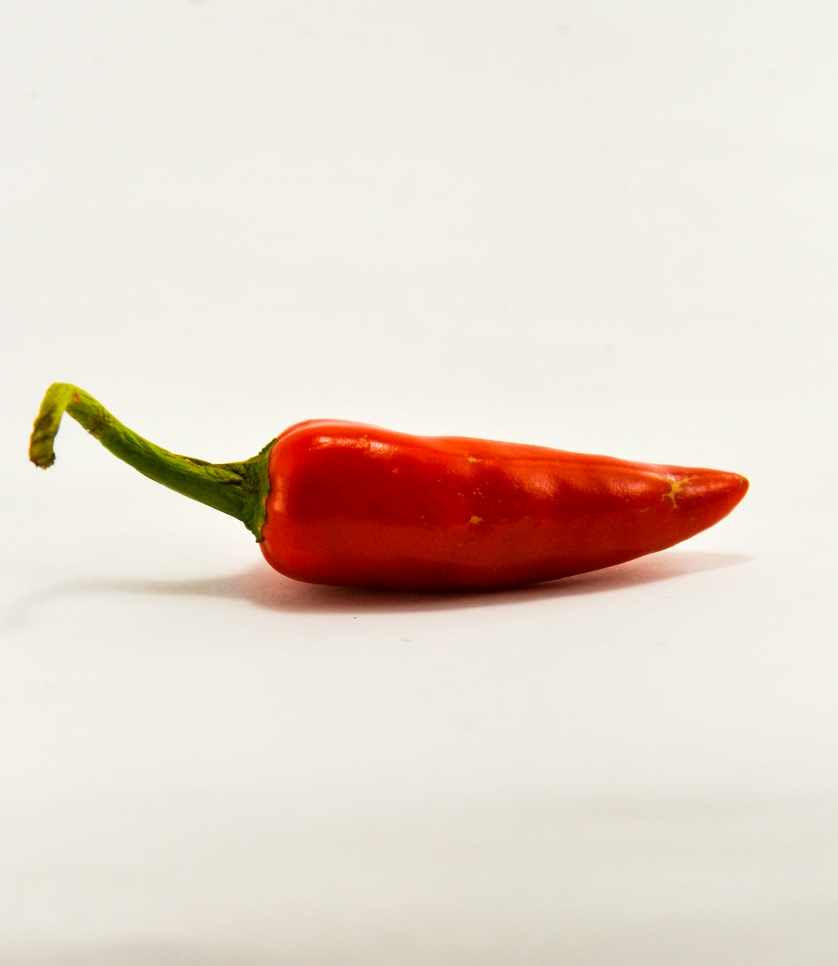 red chili on white surface