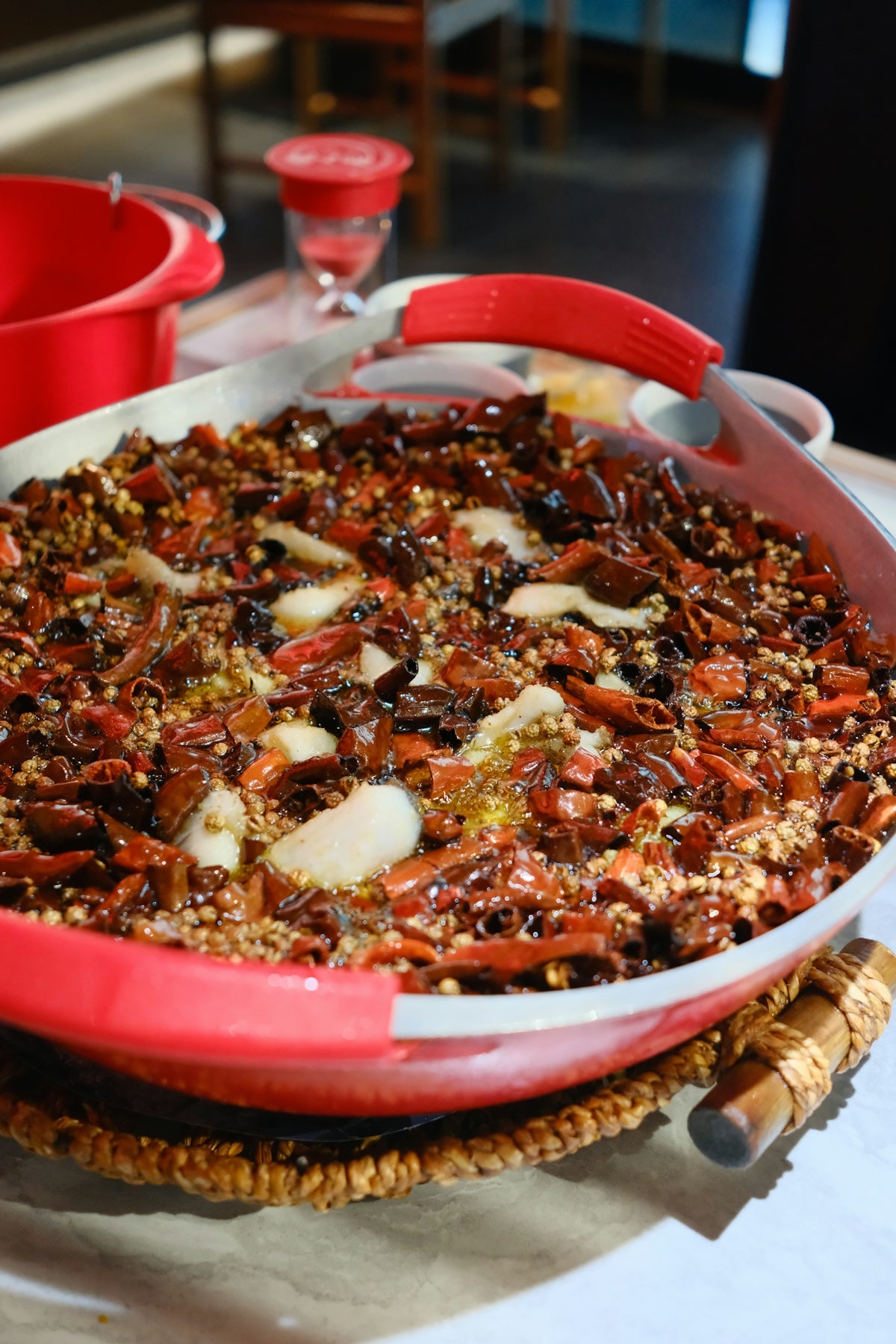 A large pan filled with spicy chili and other ingredients.
